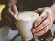 Close-Up Photo of Person Holding Cup of Coffee_front